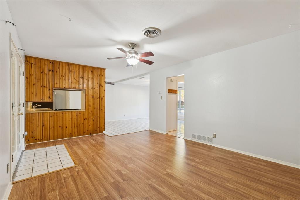 1602 England Road Arlington, TX 76013 - Photo 13 of 27 a view of an empty room with wooden floor and a window