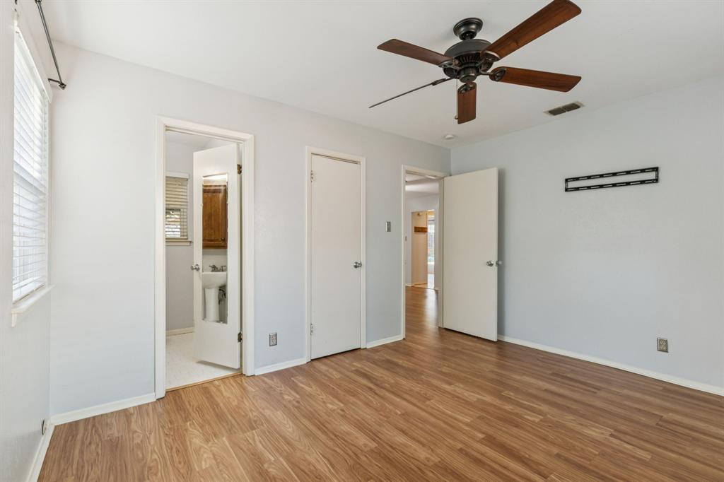 1602 England Road Arlington, TX 76013 - Photo 16 of 27 a view of a livingroom with a ceiling fan and wooden floor
