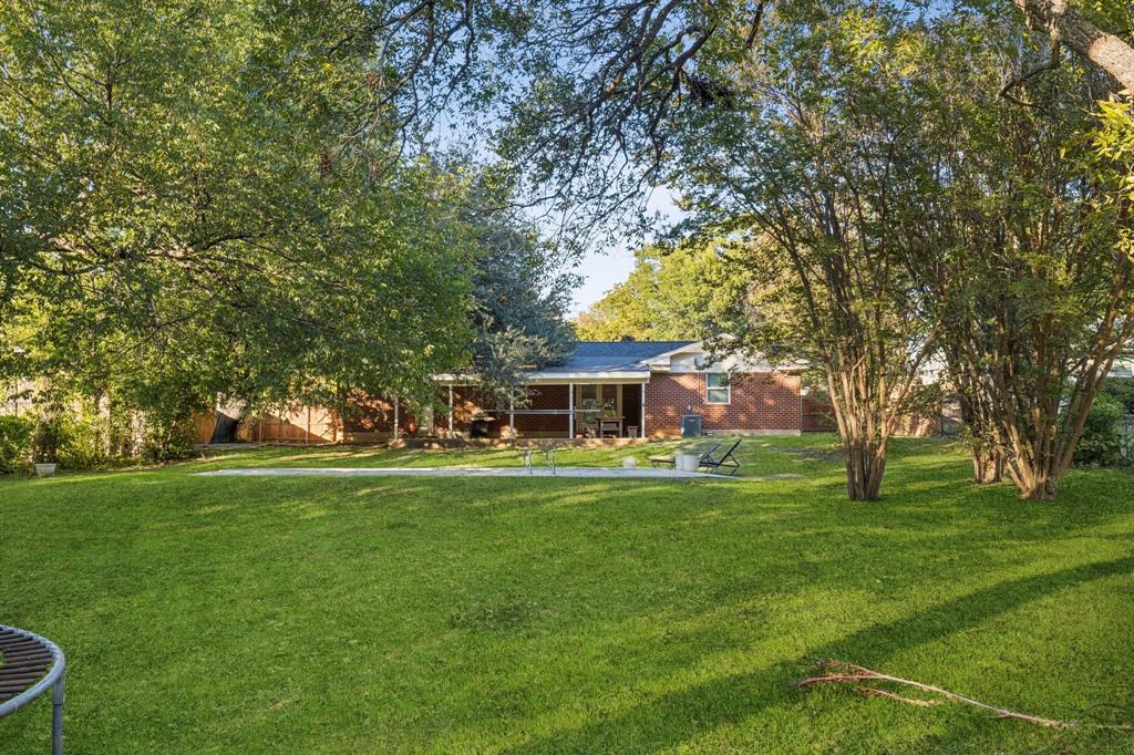 1602 England Road Arlington, TX 76013 - Photo 24 of 27 a front view of a house with a garden