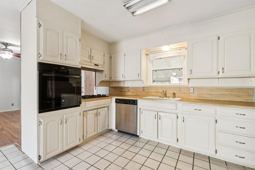 1602 England Road Arlington, TX 76013 - Photo 6 of 27 a kitchen with white cabinets and sink