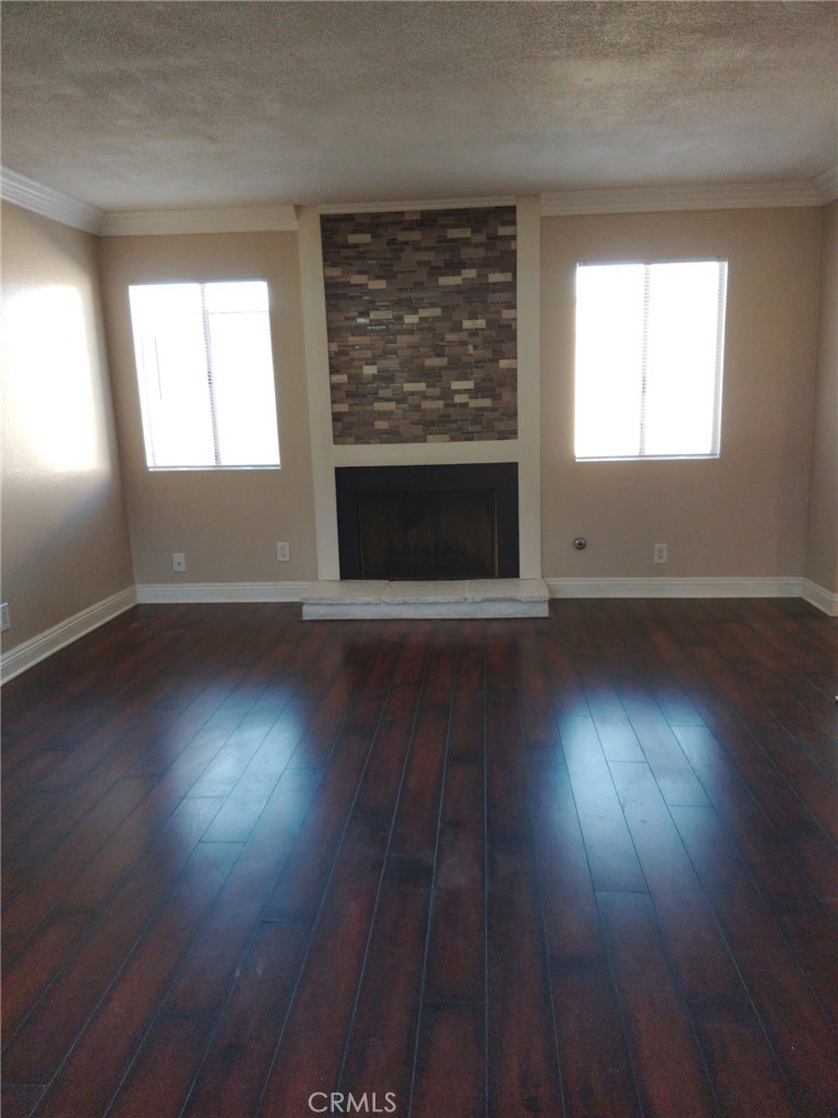 44535 La Paz Road, Unit D Temecula, CA 92592 - Photo 7 of 10 an empty room with wooden floor fireplace and windows