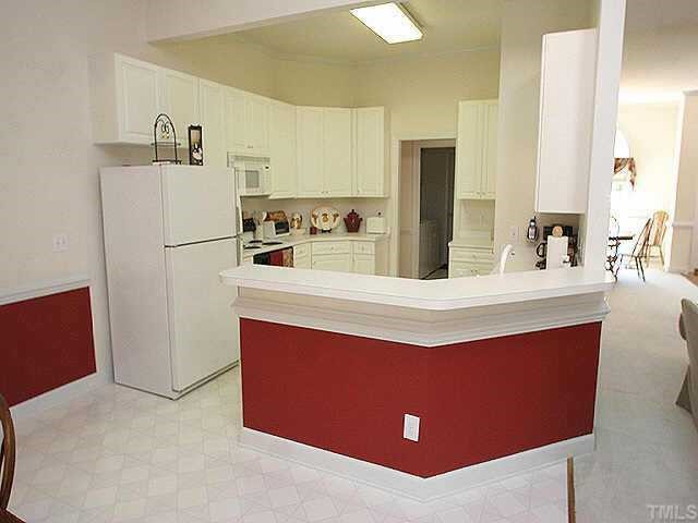 5200 Thorpe Drive Raleigh, NC 27613 - Photo 7 of 10 a kitchen with kitchen island cabinets and refrigerator