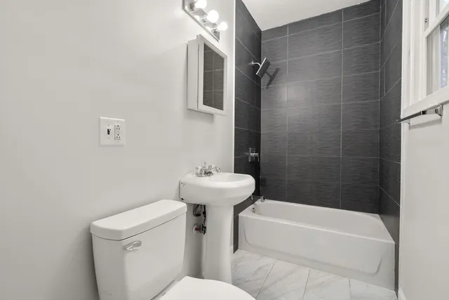 a bathroom with a sink a toilet and bathtub