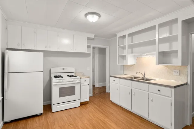 a kitchen with a sink a stove and refrigerator