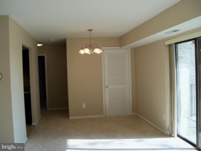 6149 Edsall Road, Unit E Alexandria, VA 22304 - Photo 4 of 24 an empty room with chandelier fan
