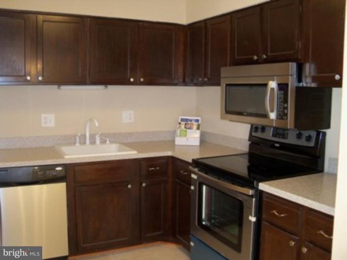 6149 Edsall Road, Unit E Alexandria, VA 22304 - Photo 8 of 24 a kitchen with a sink and steel appliances