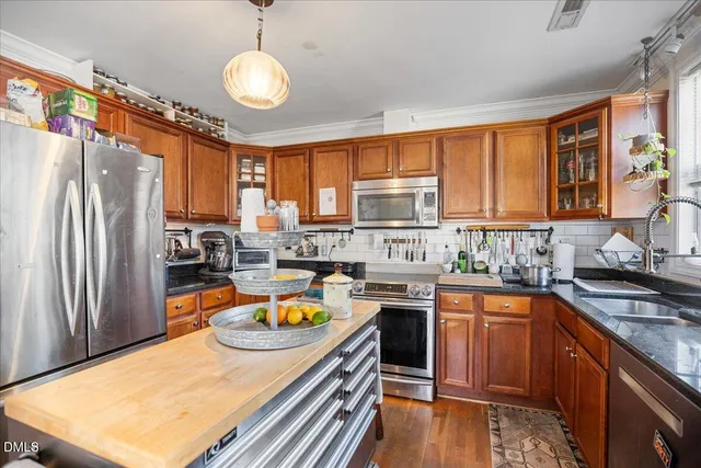a kitchen with granite countertop a sink stove and cabinets