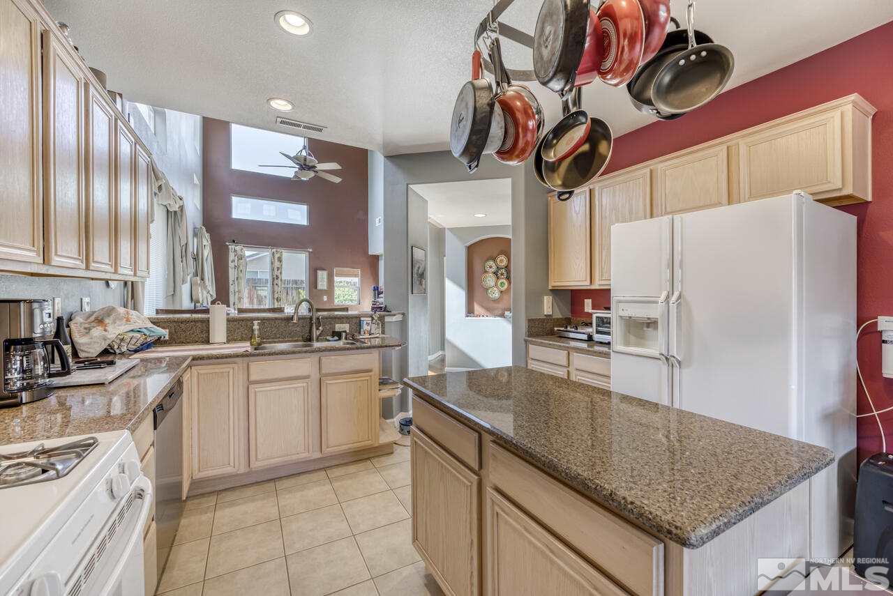 10440 Rockport Lane Reno, NV 89521 - Photo 10 of 27 a kitchen with stainless steel appliances granite countertop a sink a stove and refrigerator