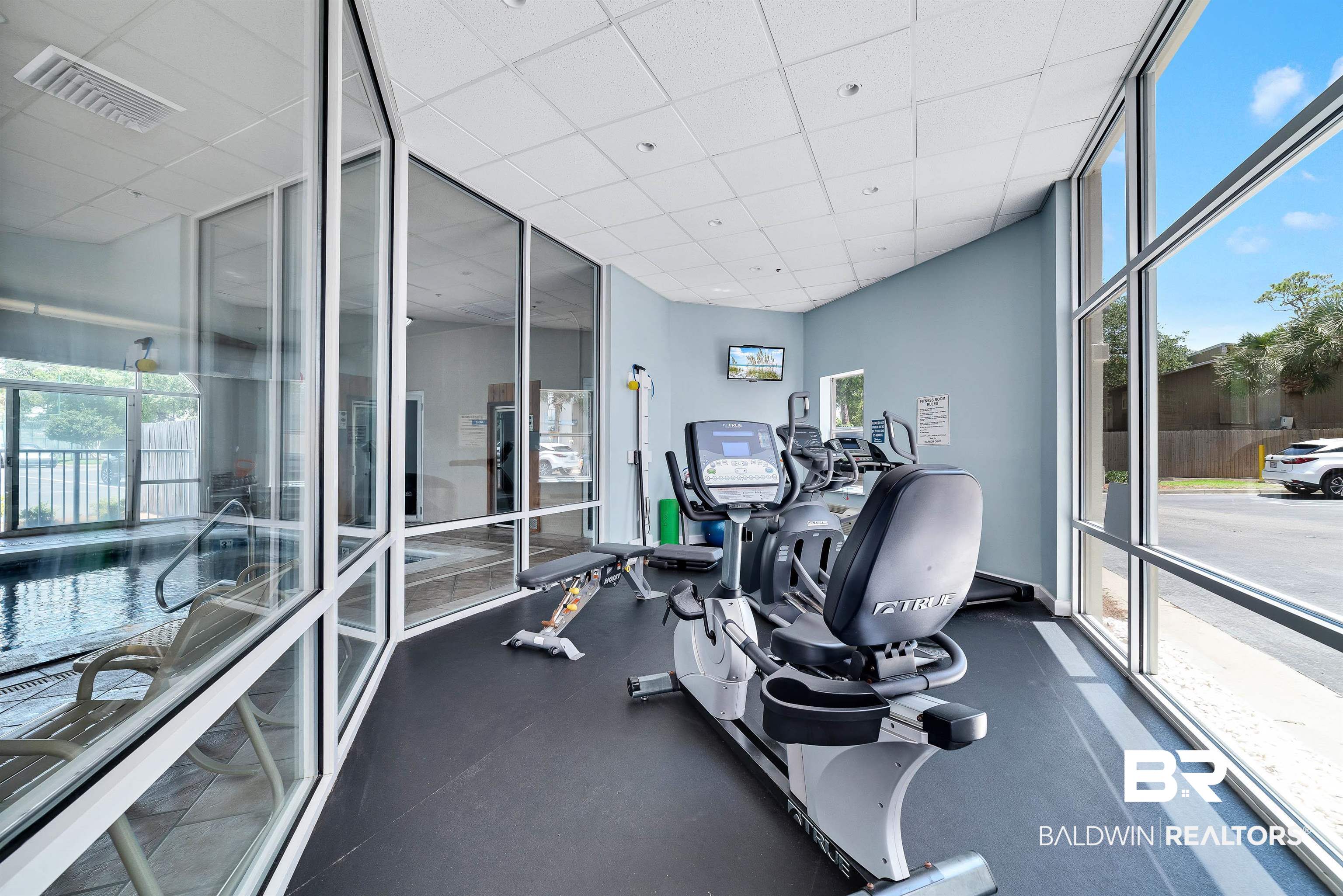 27282 Canal Road, Unit 110 Orange Beach, AL 36561 - Photo 54 of 62 Gym featuring a paneled ceiling, plenty of natural light, visible vents, and a wall of windows