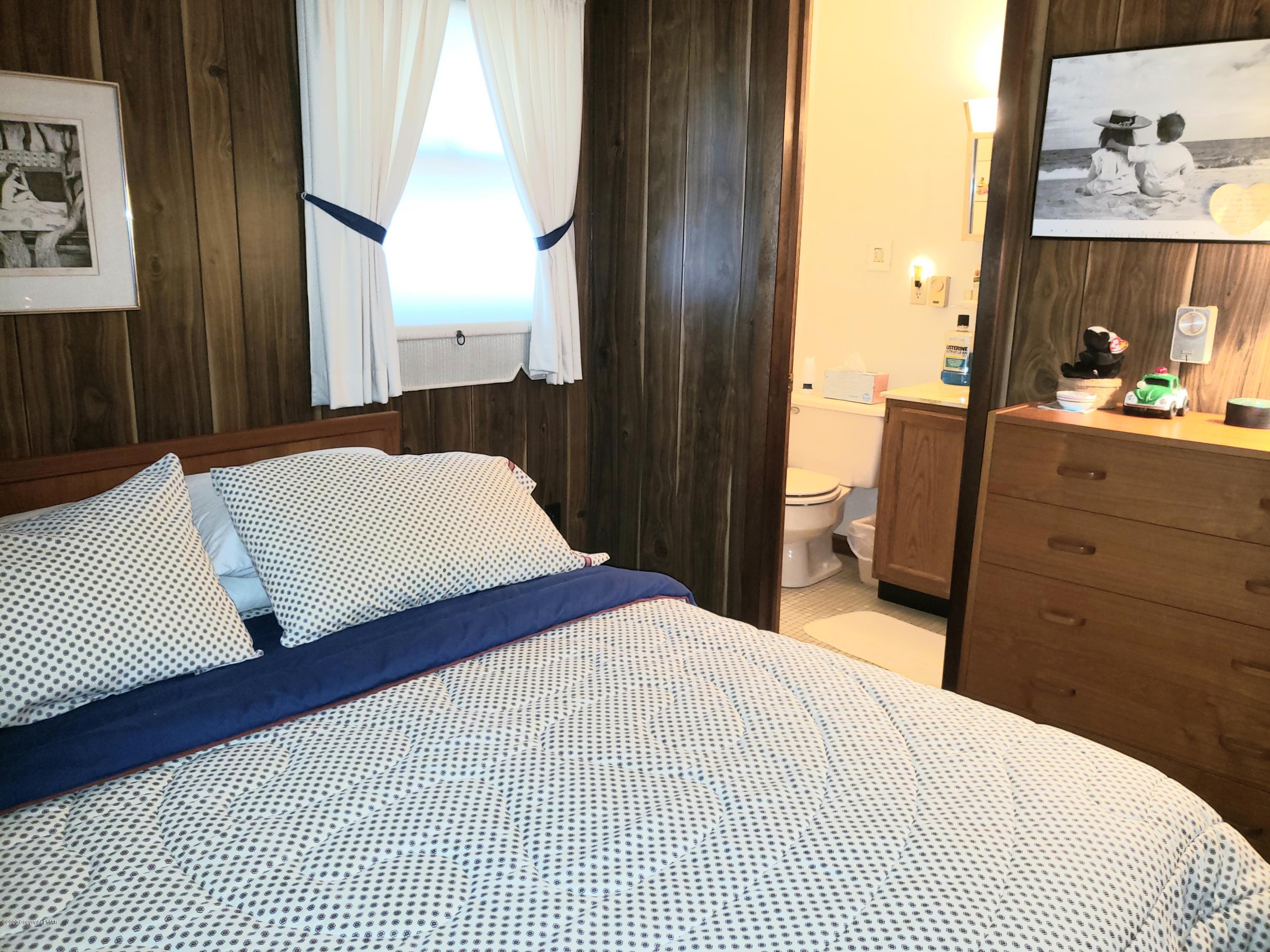 1437 Clover Road Long Pond, PA 18334 - Photo 11 of 38 a bedroom with a bed and wooden floor