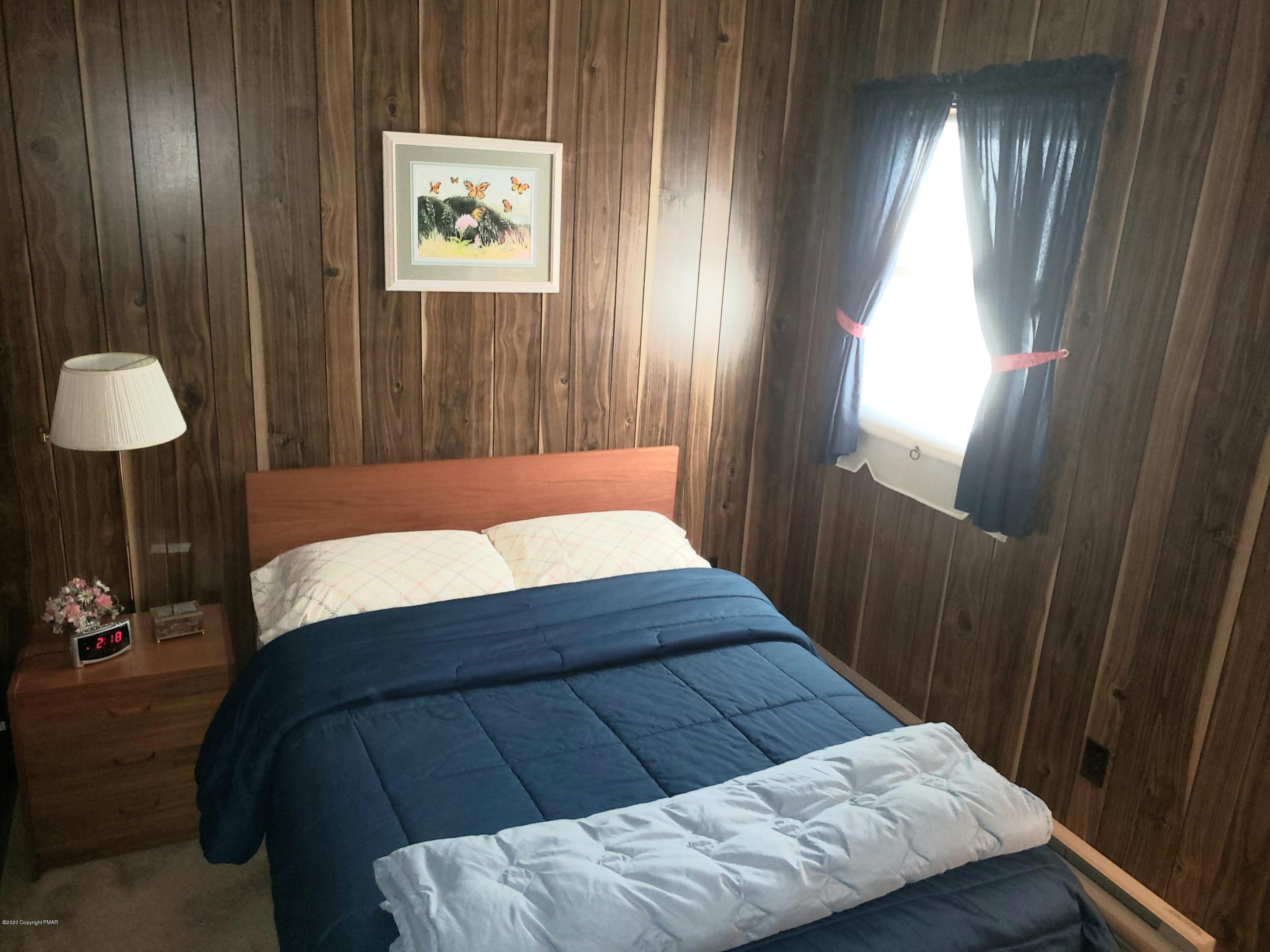 1437 Clover Road Long Pond, PA 18334 - Photo 14 of 38 a bedroom with a bed and a table in it