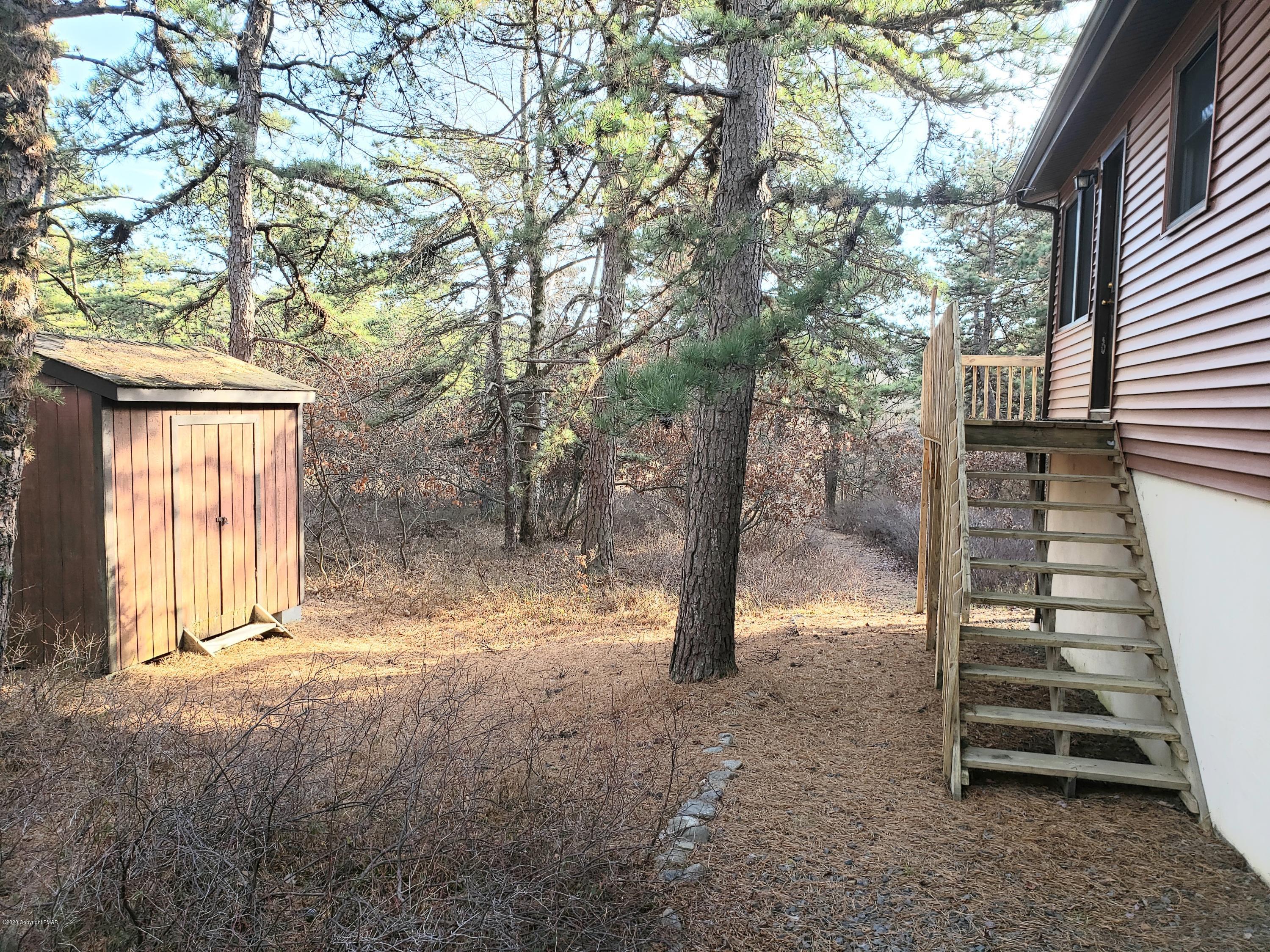 1437 Clover Road Long Pond, PA 18334 - Photo 3 of 38 a view of empty room with wooden fence and large trees