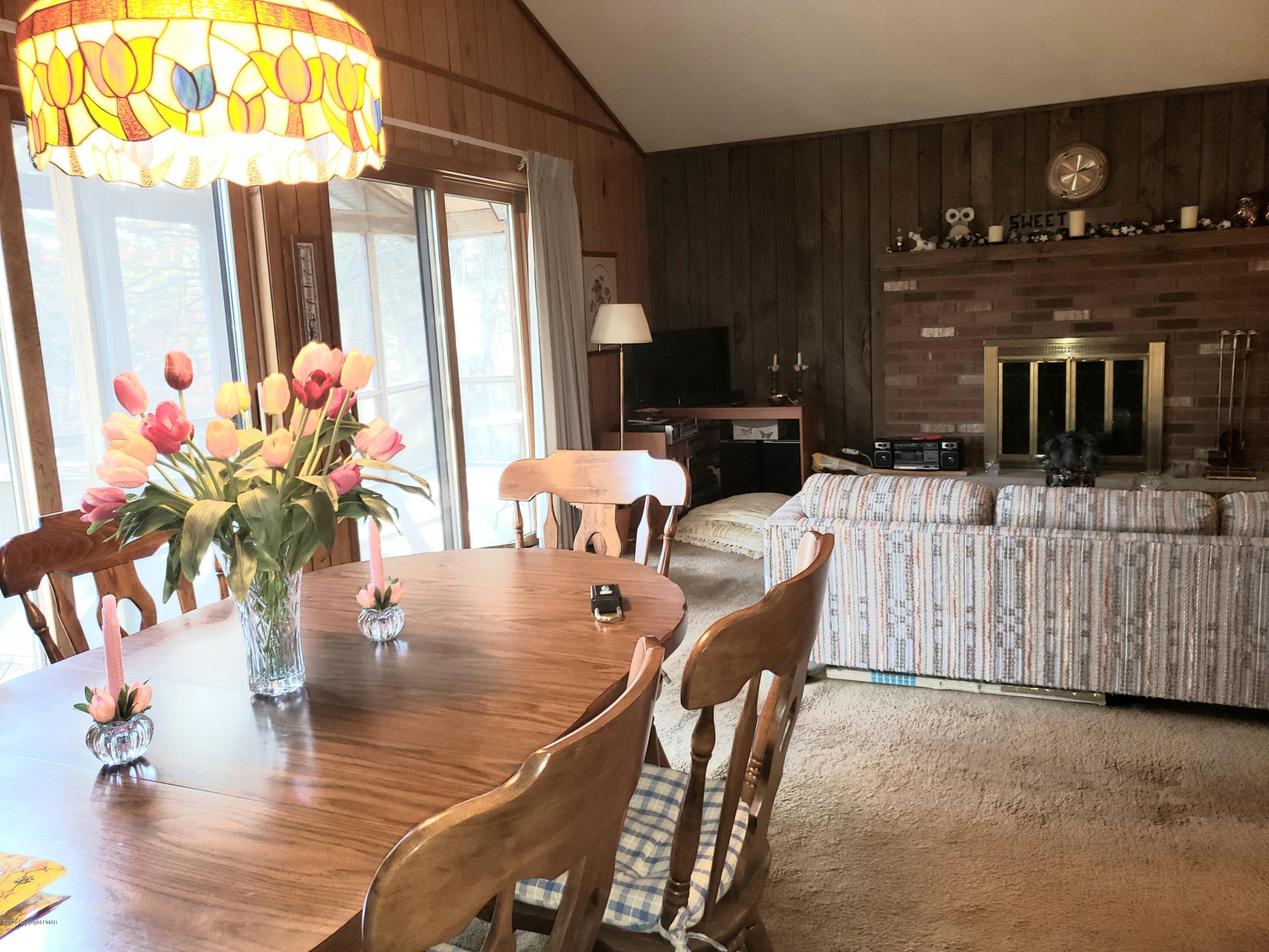 1437 Clover Road Long Pond, PA 18334 - Photo 4 of 38 a dining room with furniture potted plants and wooden floor