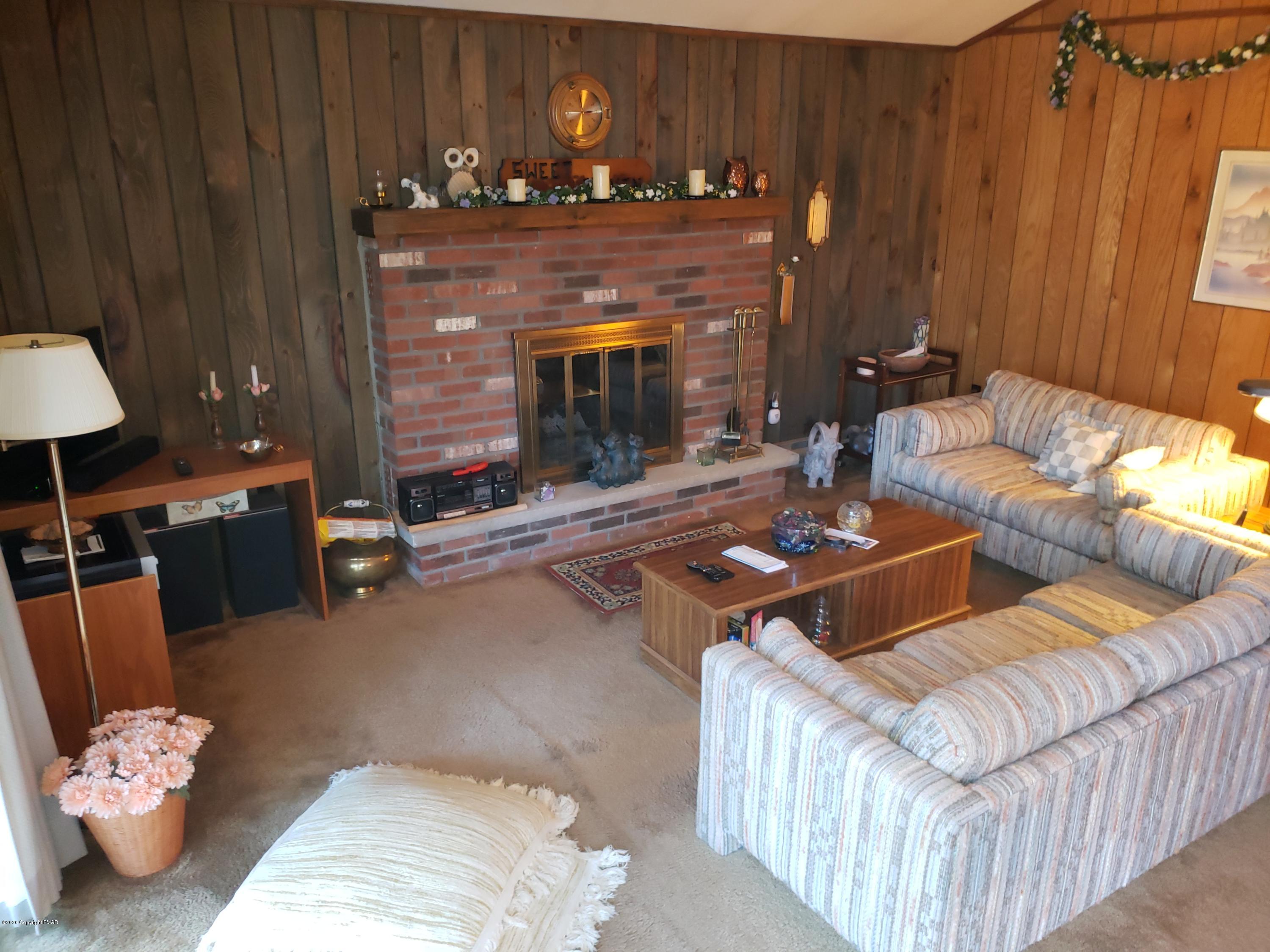 1437 Clover Road Long Pond, PA 18334 - Photo 5 of 38 a living room with furniture and a fireplace