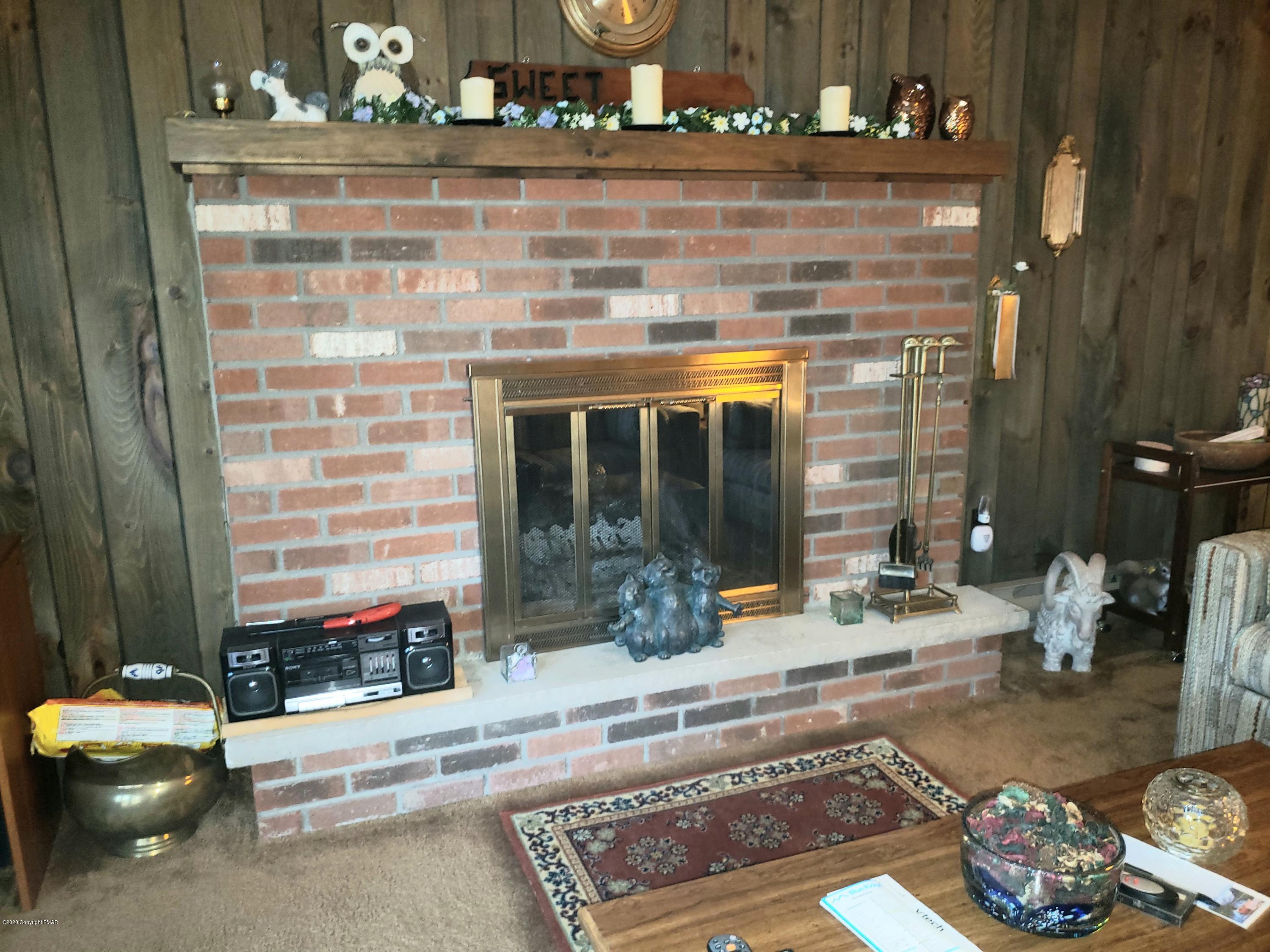 1437 Clover Road Long Pond, PA 18334 - Photo 6 of 38 a living room with furniture and a fireplace