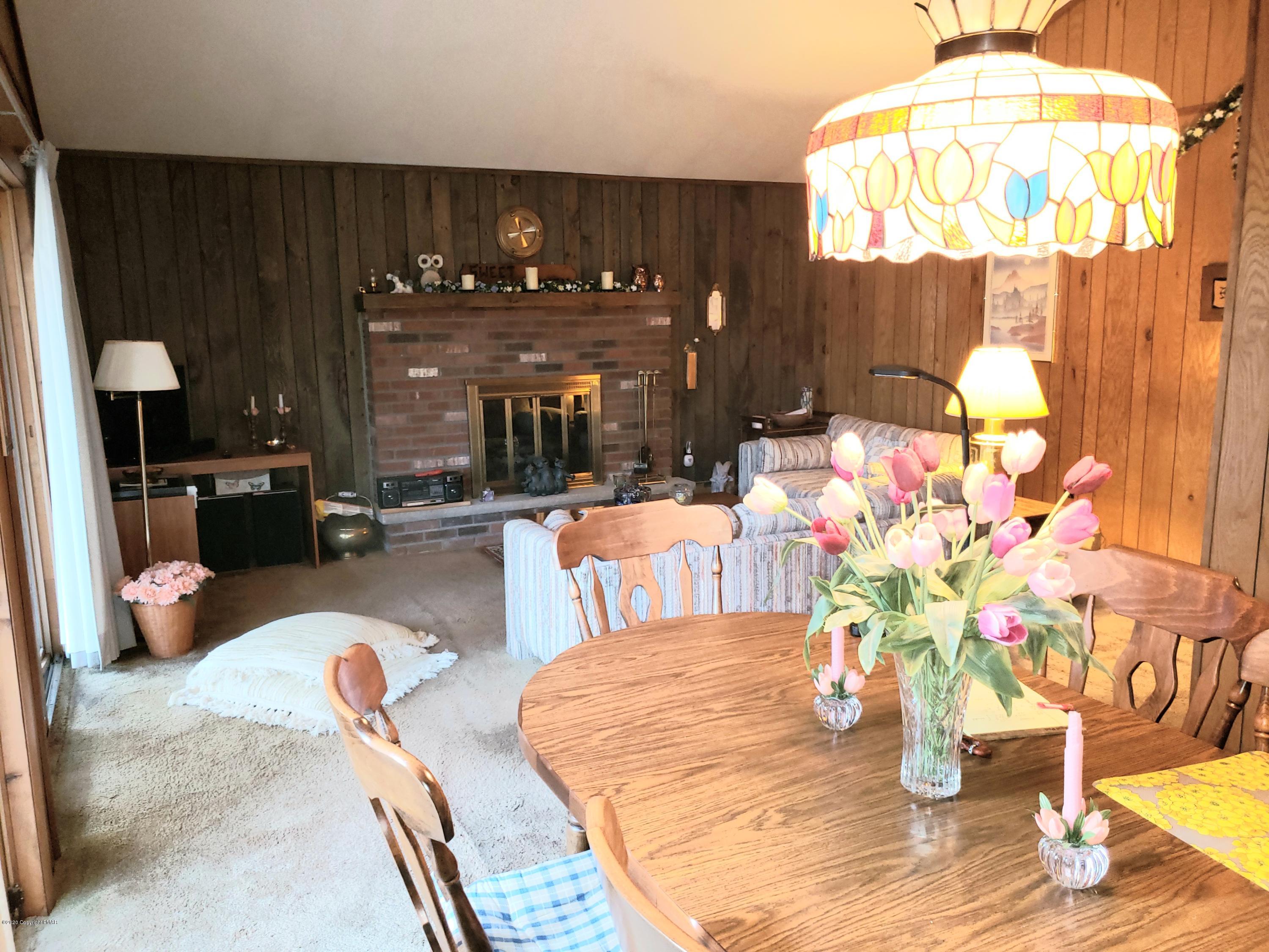 1437 Clover Road Long Pond, PA 18334 - Photo 7 of 38 a dining table with chairs and a chandelier