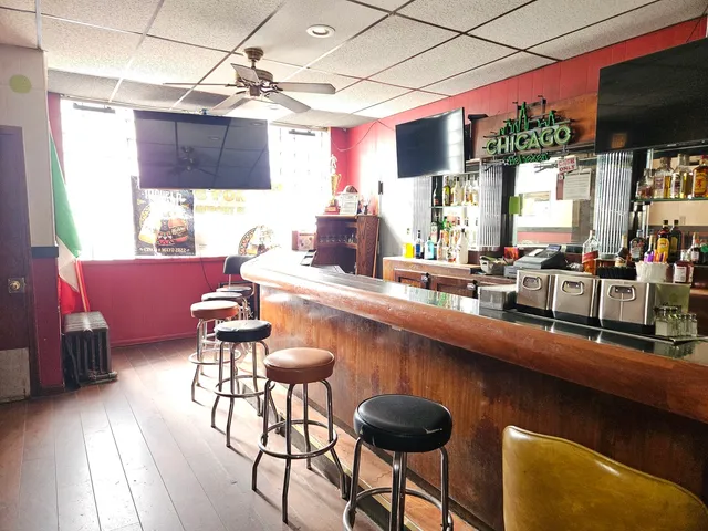 a kitchen with a table chairs stove and cabinets