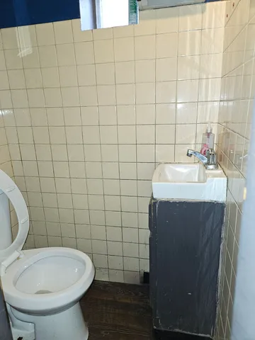 a bathroom with a sink toilet and a mirror