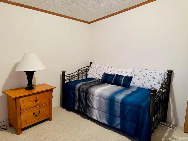 a bedroom with a bed and a night stand