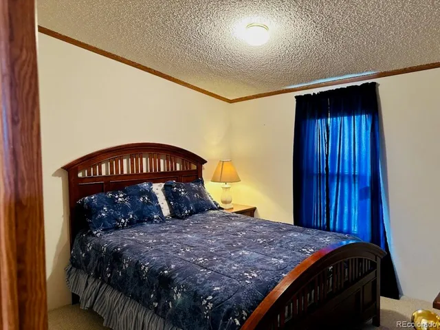 a bed sitting in a bedroom next to a window