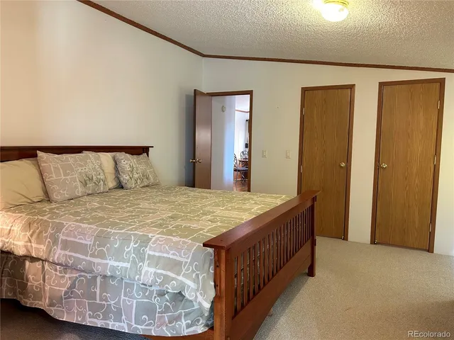 a bedroom with a bed and a mirror