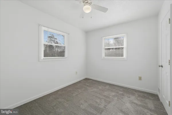 an empty room with a empty space and a ceiling fan