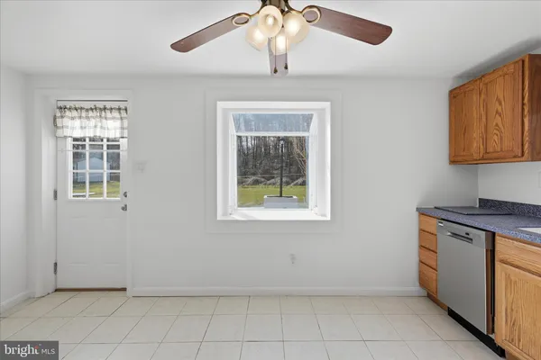 a kitchen with granite countertop a stove sink and microwave