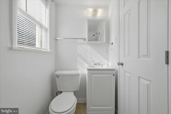 a bathroom with a sink toilet and a mirror