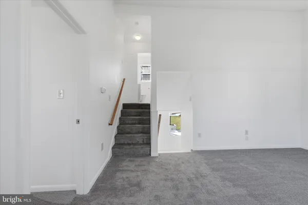 a view of an empty room with stairs