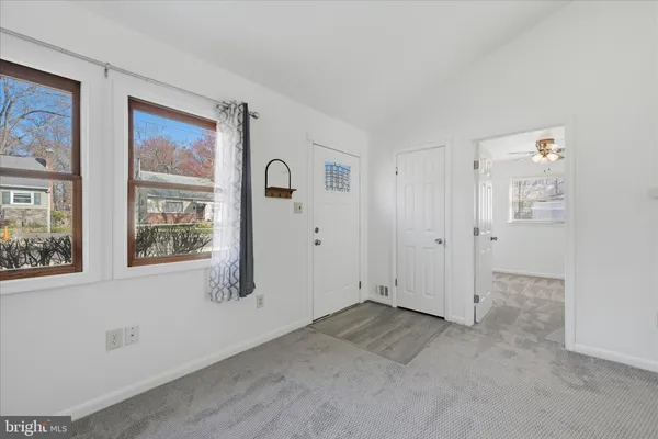 an empty room with windows and closet