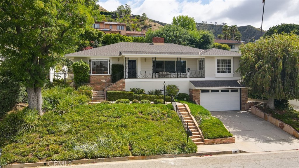 a front view of a house with garden