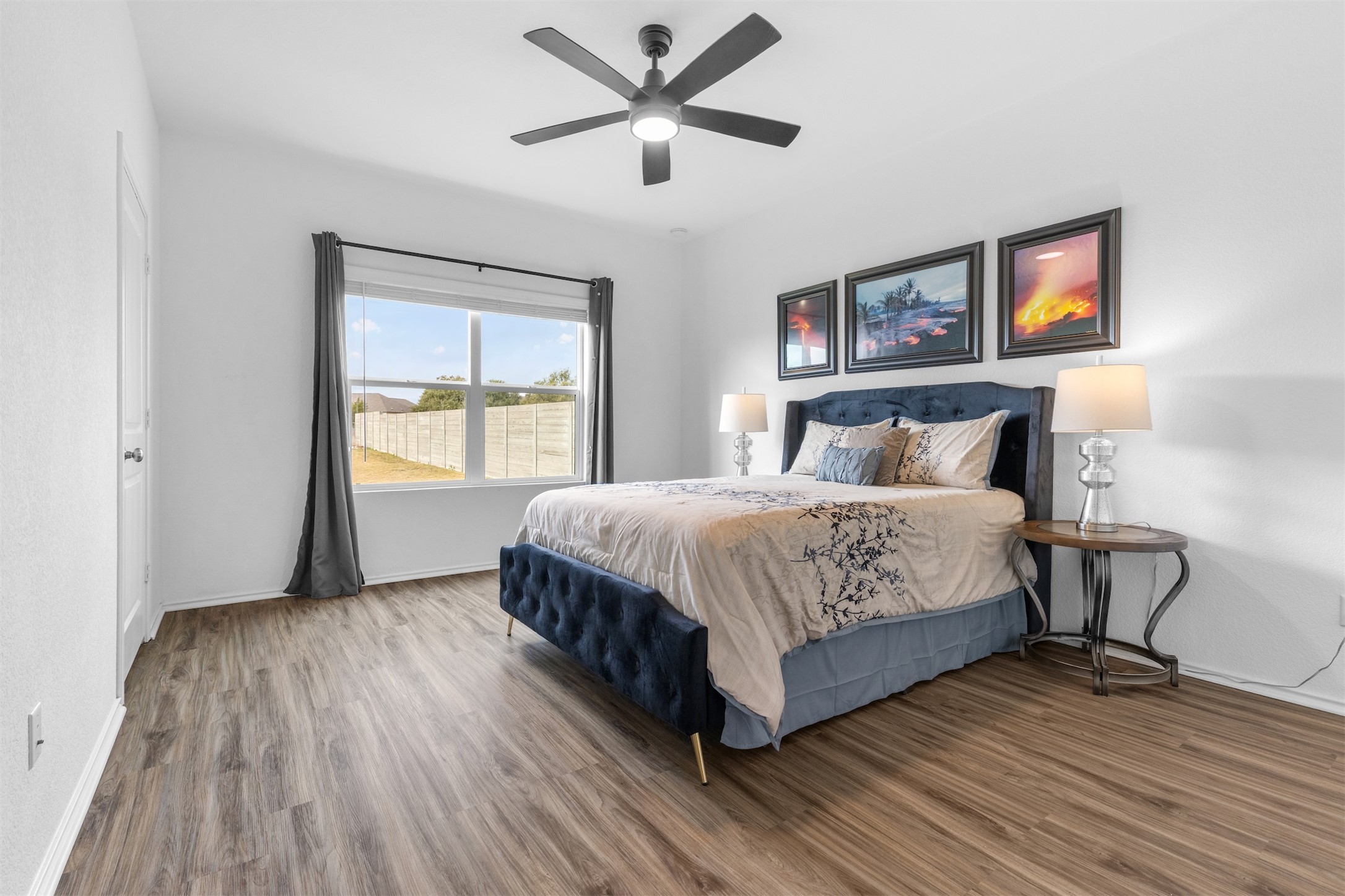 432 Clear Springs Road Georgetown, TX 78628 - Photo 7 of 35 Primary Bedroom with ceiling fan overlooking the backyard. access to Ensuite and walk-in-closet