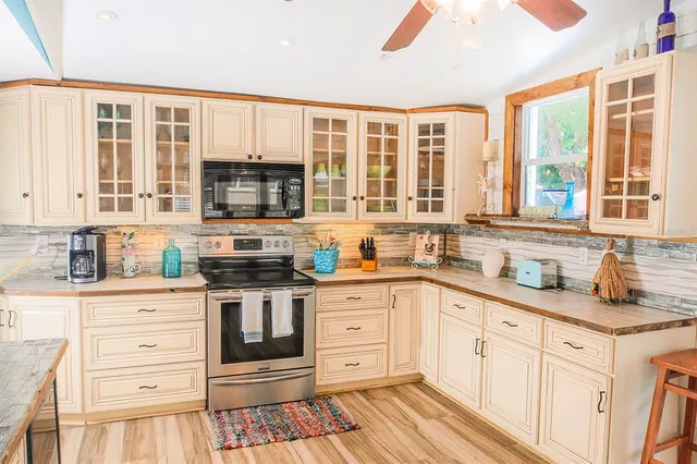 a kitchen with stainless steel appliances granite countertop a stove and a microwave