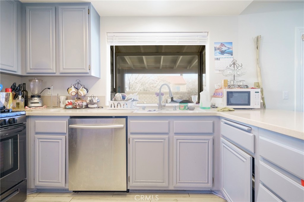 43922 Fallon Drive Lancaster, CA 93535 - Photo 19 of 36 a kitchen with granite countertop white cabinets and sink