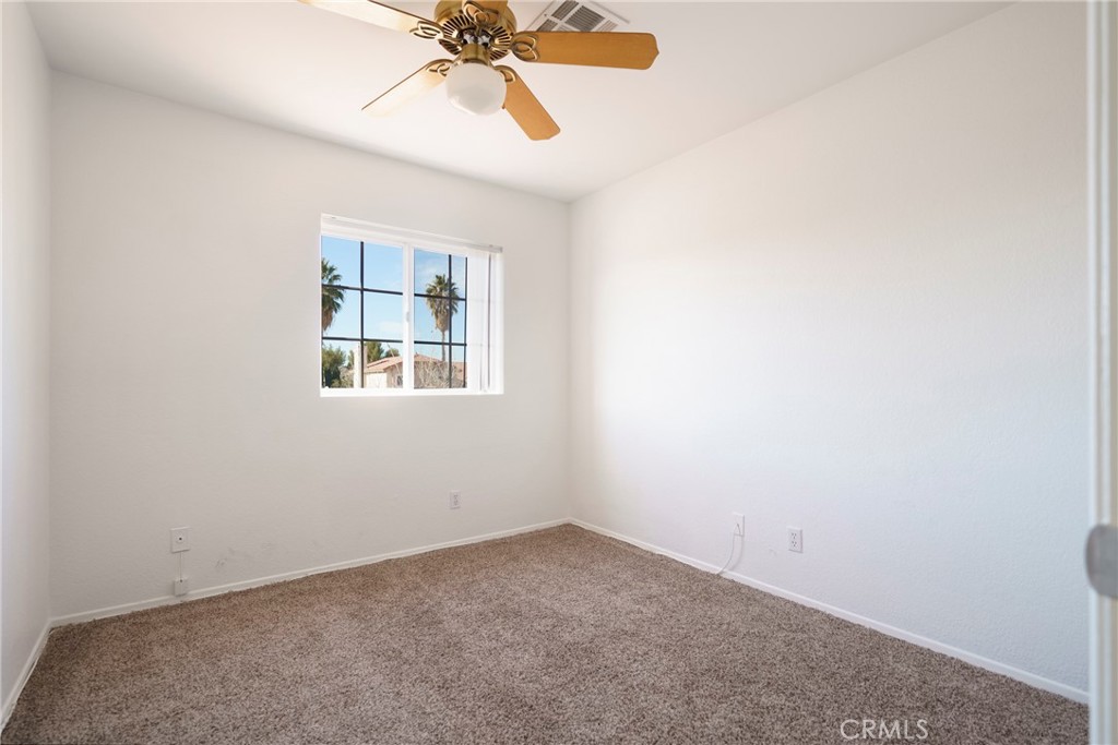 43922 Fallon Drive Lancaster, CA 93535 - Photo 21 of 36 an empty room with a window and a fan