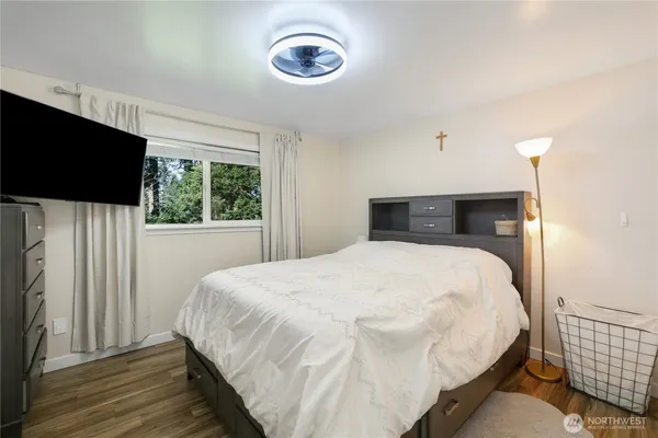 a bedroom with a bed and a flat tv screen
