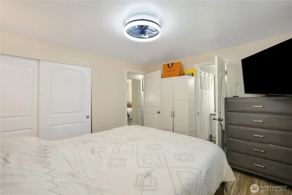 a bedroom with a bed and a flat screen tv