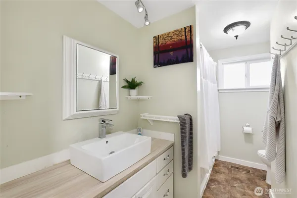 a bathroom with a sink a mirror and a shower