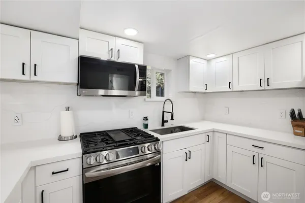 a kitchen with cabinets stainless steel appliances and wooden cabinets