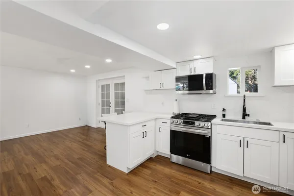 a kitchen with a sink stove top oven and cabinets