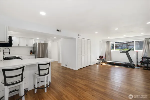 a view of a kitchen with workspace and wooden floor