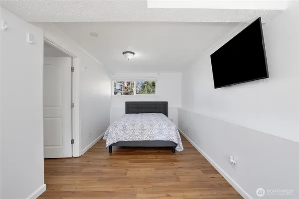 a bedroom with a bed and a flat screen tv