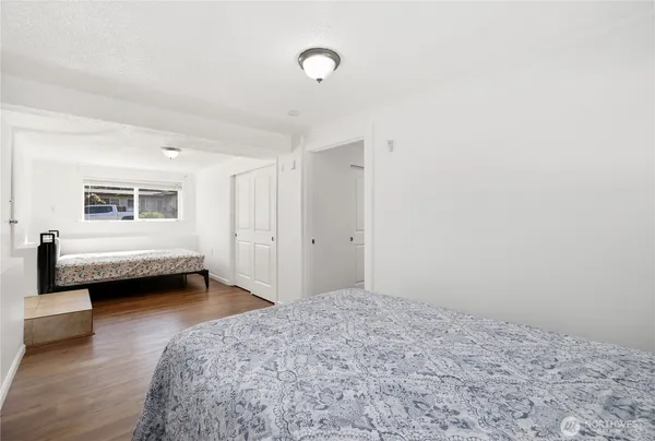 a view of a bedroom with a bed and a window