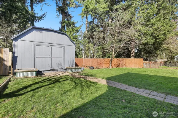 a view of backyard with small cabin