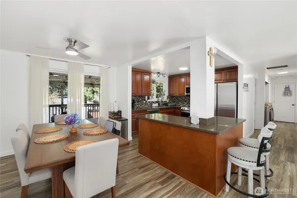 a living room with kitchen island furniture and a view of kitchen