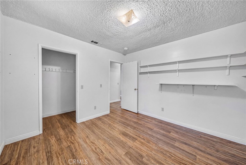 29078 Bradley Road Menifee, CA 92586 - Photo 31 of 42 a view of empty room with wooden floor