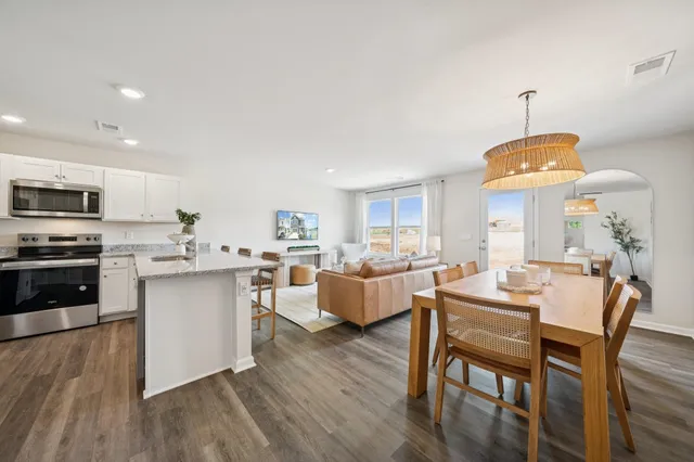 a kitchen with counter space dining table and chairs