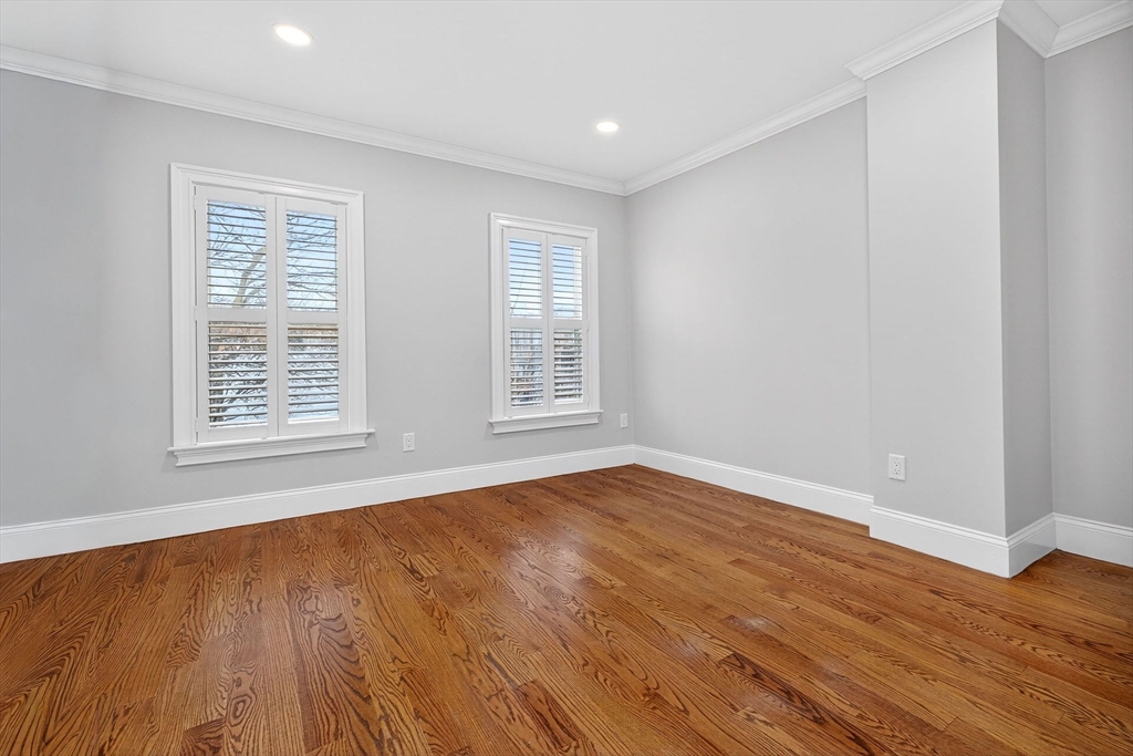 137 N Street, Unit 3 Boston, MA 02127 - Photo 17 of 28 a view of an empty room with wooden floor and a window