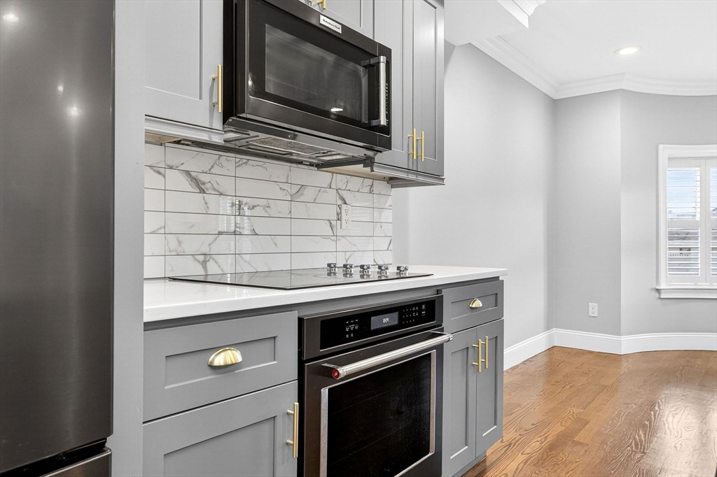 137 N Street, Unit 3 Boston, MA 02127 - Photo 6 of 28 a kitchen with a stove and a microwave