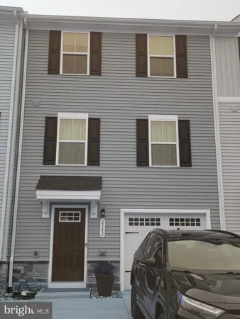 a front view of a house with parking space